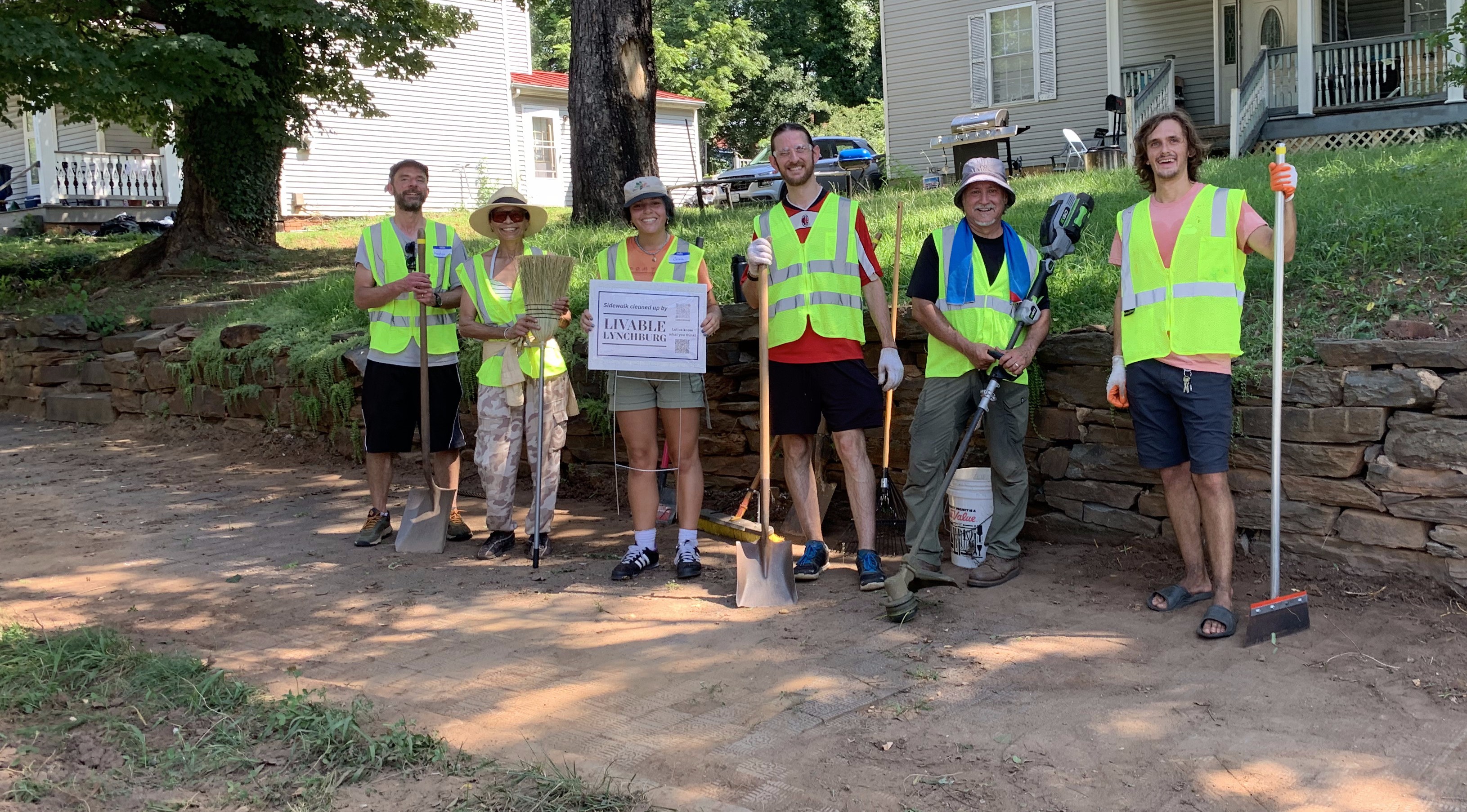 Livable Lynchburg and community members cleaning up a Polk Street sidewalk.